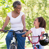 Grandmother and Granddaughter exercising for American Heart Month