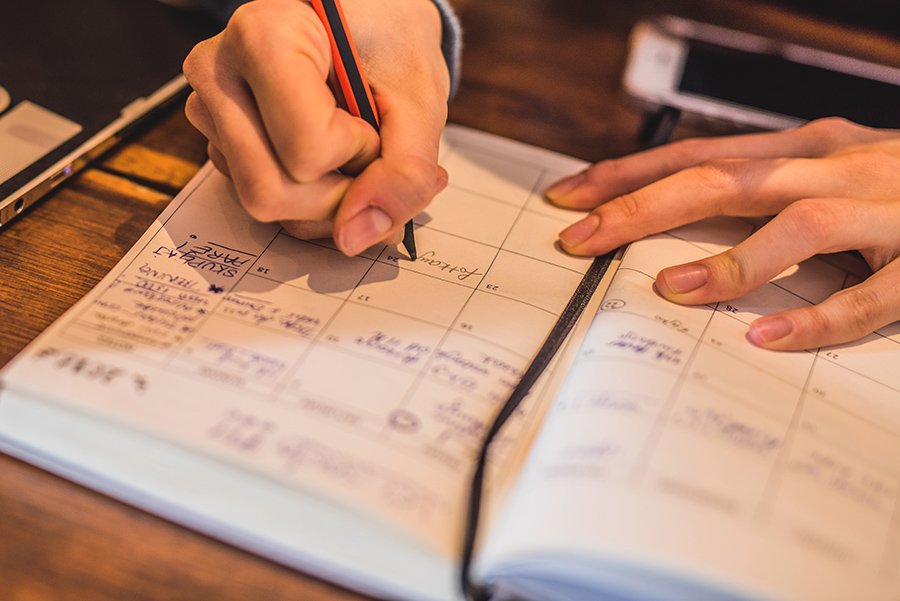 Close-up of young woman taking notes.