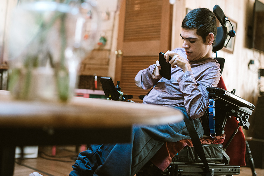 Confident Young Man In Wheelchair At Home