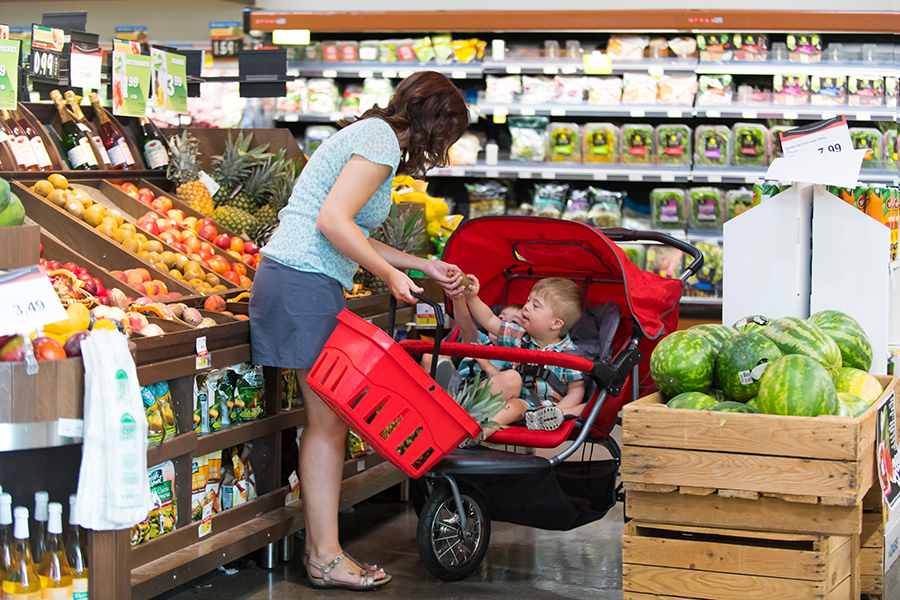 Mom at the grocery store with his son with Down Syndrome