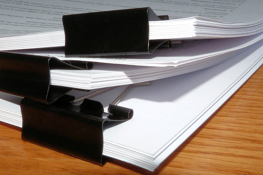 Stack Of Legal Office Papers On Desk With Binder Clip