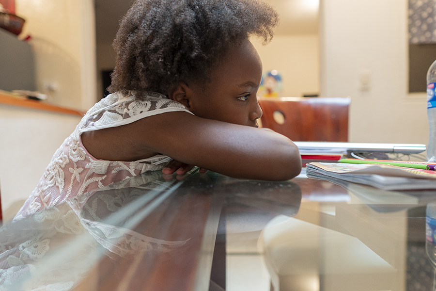 Afro-Latin girl looking at camera in portrait with sad and lonely face