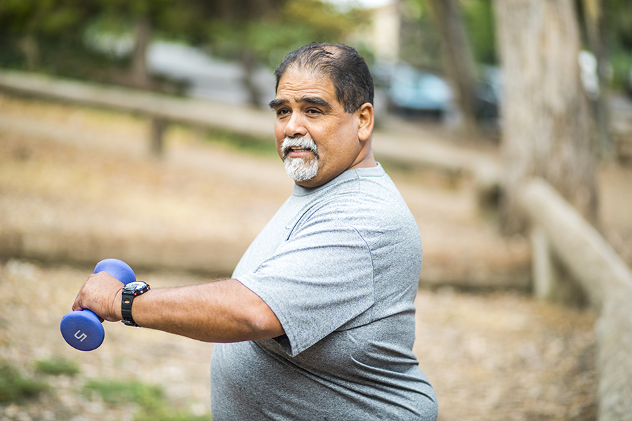 Senior Mexican Man Working Out Lifting Weights